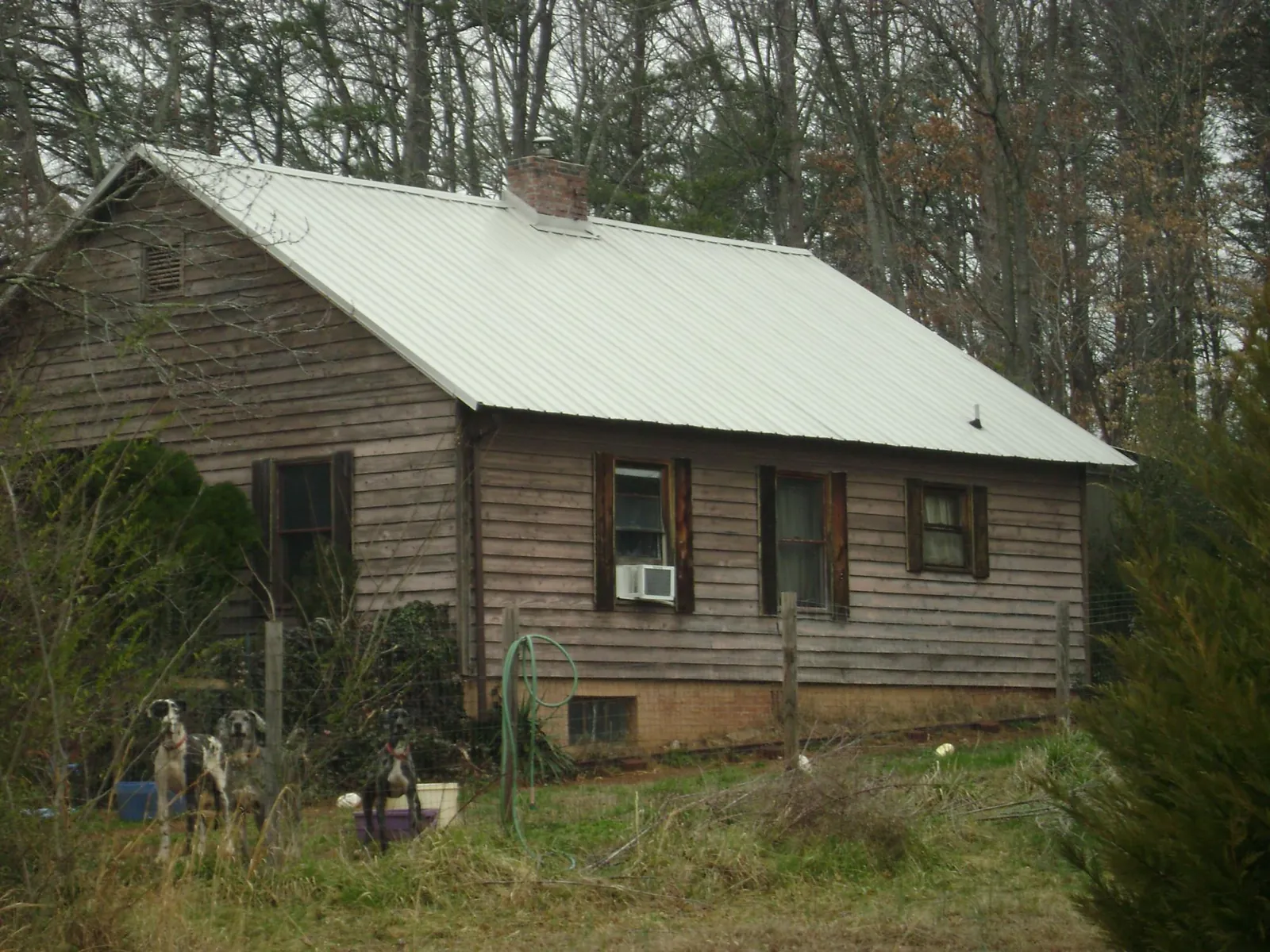 White metal roof on an old wood sided farmhouse, from a Metal Roof Installation job in Nokesville